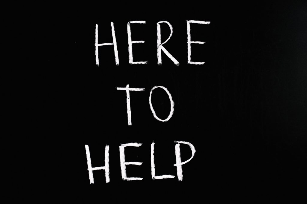 An image displaying the text: "Here to help."