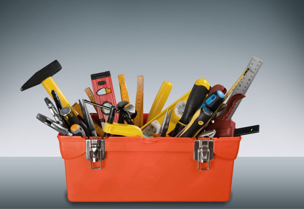 Tool box with tools displayed on a gray background